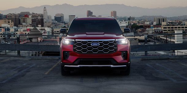 The front of a 2026 Ford Explorer SUV with the headlamps illuminated