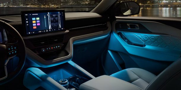 The interior of a 2026 Ford Explorer SUV with Ambient Lighting on