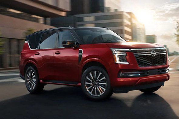2026 Nissan Armada NISMO driving through a city center showing a contrasting roof