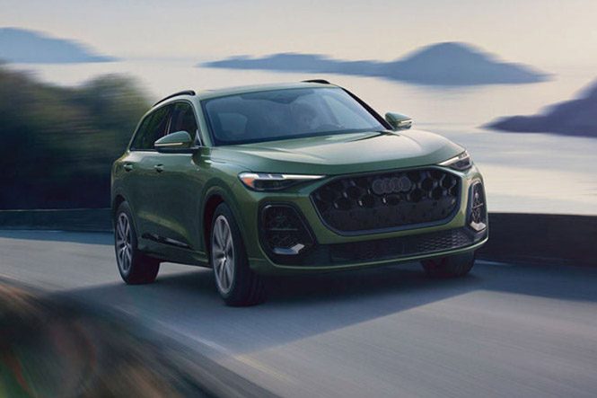 Three-quarter front view of the 2026 Audi Q5 accelerating on a mountainside road.