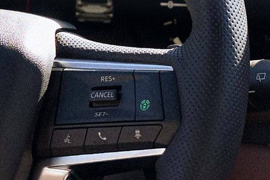 Close up on the traffic jam assist controls on the steering wheel of the 2026 Mitsubishi Outlander SUV