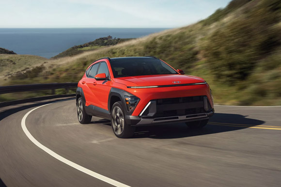 Front three-quarter view of the 2026 Hyundai Kona Limited in Orange Pearl