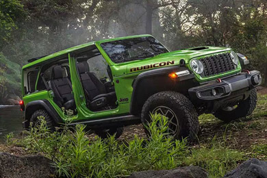 Green 2026 Jeep Wrangler, four-door version with doors removed